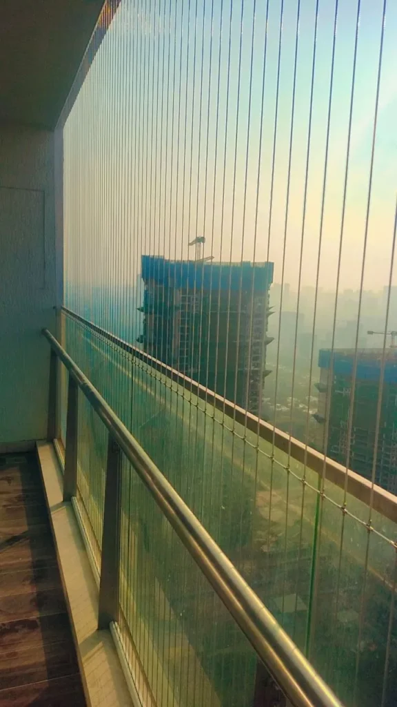 High-floor balcony with invisible grills overlooking the city